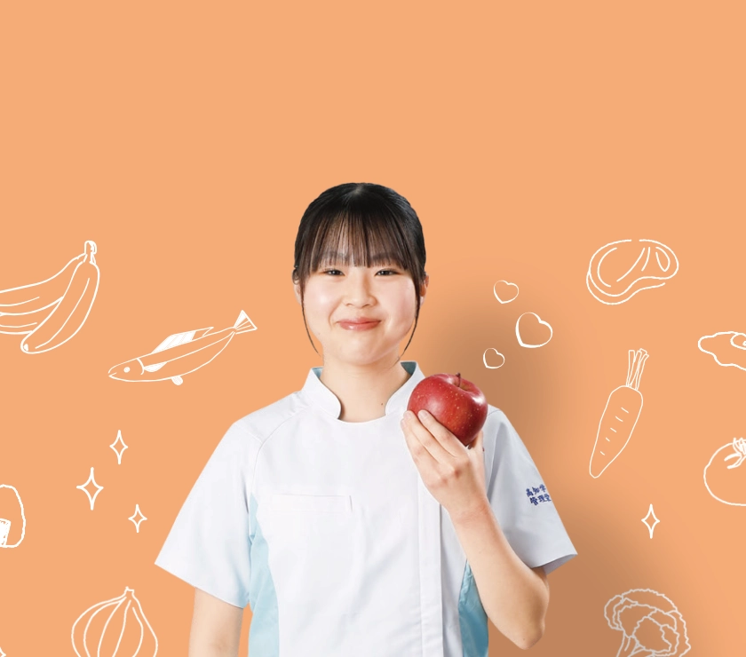 りんごを持つ管理栄養学科の学生